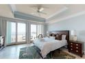 Ocean view bedroom with a king-size bed and access to a balcony at 113 E Arctic Ave # B, Folly Beach, SC 29439