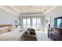 King bedroom with ocean view, two armchairs, and private balcony access at 113 E Arctic Ave # B, Folly Beach, SC 29439