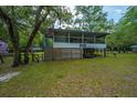 Charming elevated cottage on a spacious lot with lush landscaping at 100 Hannibal Trl, Ridgeville, SC 29472