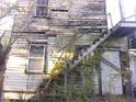 Run-down exterior with weathered wood siding and exposed staircase at 5 President Pl, Charleston, SC 29403
