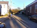 Residential street view with parked cars and houses at 5 President Pl, Charleston, SC 29403