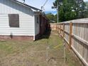Side yard view with wooden fence and AC unit at 308 N Live Oak Dr, Moncks Corner, SC 29461