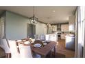 Kitchen and dining area featuring a farmhouse table and modern lighting at 516 Hayes Park Blvd # 1, Johns Island, SC 29455