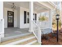 Front porch with white columns and wooden steps at 2042 Bullyard Sound Way, Awendaw, SC 29429