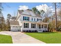 Two-story white house with attached garage at 2042 Bullyard Sound Way, Awendaw, SC 29429
