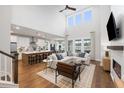 Open living space with a sectional sofa, fireplace, and kitchen island at 5000 Middleton Dr, Goose Creek, SC 29445