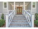 Front entry with brick steps and white railings at 19 Bradley Pasture Way, Ravenel, SC 29470