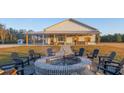 Brick firepit with surrounding seating in the backyard at 6500 Parkers Ferry Rd, Adams Run, SC 29426