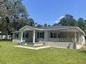 Light beige house with a large front yard at 902 Poplar St, Walterboro, SC 29488