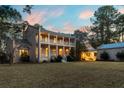 Two story house with a large front yard, and detached garage at 8340 Crooked Creek Ln, Edisto Island, SC 29438