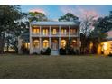 Two story house with a large front yard and a metal roof at 8340 Crooked Creek Ln, Edisto Island, SC 29438