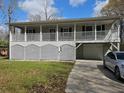 Raised home with covered porch, attached garage, and landscaped yard at 757 Backfield Rd, Walterboro, SC 29488