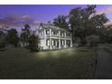 Two story home at dusk with landscaping and neighborhood view at 1003 Wichman St, Walterboro, SC 29488