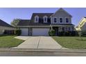 Two-story house with three-car garage and landscaped yard at 2035 Triple Crown Ln, Ridgeville, SC 29472