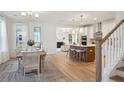 Open concept dining room with hardwood floors and kitchen views at 8749 Revival Round, North Charleston, SC 29420