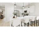 Modern kitchen with white shaker cabinets, quartz countertops, and island seating at 208 Greenling St, Goose Creek, SC 29445