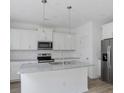 White kitchen with granite countertops and stainless steel appliances at 8705 Revival Rd, North Charleston, SC 29420