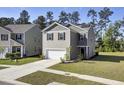 Two-story house with gray siding, white garage door, and landscaped yard at 466 Cedarview Rd, Summerville, SC 29486