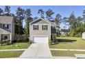 Two-story house with gray siding, white garage door, and landscaped yard at 466 Cedarview Rd, Summerville, SC 29486