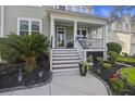 Inviting front porch with white columns and stairs at 3336 Toomer Kiln Cir, Mount Pleasant, SC 29466