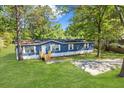 Blue mobile home on a large lot with grassy yard at 227 Koger Dr, Summerville, SC 29483