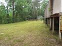 Large backyard with mature trees and a wooden fence at 31 Hannibal Dr, Ridgeville, SC 29472