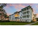 Three-story building with white siding, balconies, and landscaped grounds at 345 Longshore St # 933, Charleston, SC 29492