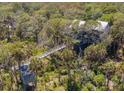 Elevated view of a stunning house with a boardwalk over lush greenery at 403 Pelican Flight Dr, Dewees Island, SC 29451