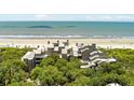 Wide aerial view of the property, showing the beach and complex buildings at 4426 Sea Forest Dr, Kiawah Island, SC 29455