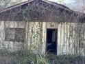 Overgrown exterior with KEEP OUT sign at 1918 Sol Legare Rd, Charleston, SC 29412