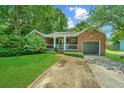 Brick home with a covered porch and nicely landscaped yard at 480 Magnolia Rd, Charleston, SC 29407