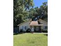 Cute yellow house with blue shutters and a well-maintained lawn at 106 Teddy Ct, Summerville, SC 29485