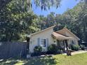 Cute yellow house with blue shutters and a well-maintained lawn at 106 Teddy Ct, Summerville, SC 29485