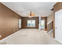 Spacious living room with carpeted floor, ceiling fan, and fireplace at 7468 Northgate Dr, Hanahan, SC 29410