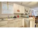 White kitchen cabinets, stainless steel dishwasher, and granite countertops at 2832 Ranger Dr, North Charleston, SC 29405