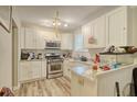 White kitchen cabinets, stainless steel appliances, and granite countertops at 2832 Ranger Dr, North Charleston, SC 29405