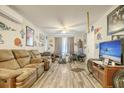 Living room with brown leather couches, a large TV, and sports memorabilia at 2832 Ranger Dr, North Charleston, SC 29405
