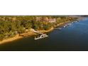Aerial view of waterfront property with private docks and lush landscaping at 1473 Jeremy Cay Ct, Awendaw, SC 29429