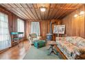 Living area with wood walls, wood floors, and vintage furniture at 712 W Ashley Ave, Folly Beach, SC 29439