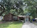Brick house with large tree and driveway at 1056 Yorktown Dr, Charleston, SC 29412