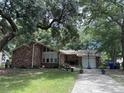 Brick house with large tree and driveway at 1056 Yorktown Dr, Charleston, SC 29412