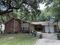 Brick house with large tree and driveway at 1056 Yorktown Dr, Charleston, SC 29412
