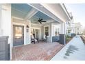 Brick porch with ceiling fan and seating area at 420 Carolina Cherry Ct # 201, Charleston, SC 29414