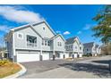 Row of townhouses featuring attached garages and balconies at 420 Carolina Cherry Ct # 201, Charleston, SC 29414