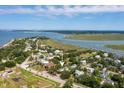 Aerial view of a house near the water with a beautiful neighborhood at 1220 Middle St, Sullivans Island, SC 29482
