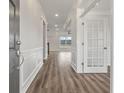 Bright entryway with hardwood floors, white trim, and a view into the living room at 115 Ashley Cove Way, Summerville, SC 29483