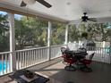 Screened porch with table and chairs, offering a view of the backyard at 7 Seahorse Ct, Isle of Palms, SC 29451