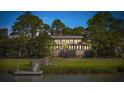 Luxury waterfront home with expansive windows and private dock at 3067 Marshgate Dr, Seabrook Island, SC 29455