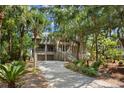 Two-story home with a spacious driveway and lush landscaping at 3067 Marshgate Dr, Seabrook Island, SC 29455