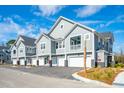 Gray townhouses with attached garages and front porches at 420 Carolina Cherry Ct # 101, Charleston, SC 29414